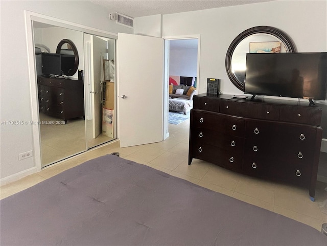 3660 NE 166th St Unit 307, North Miami Beach, FL 33160 - bedroom with light tile patterned floors and a closet