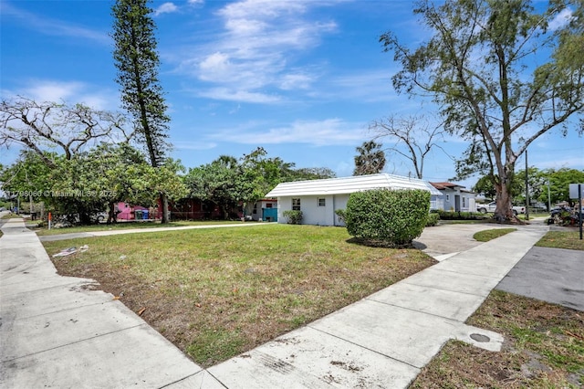 2701 NW 18th Ter, Oakland Park, FL 33311 - view of home's exterior with a yard and concrete driveway