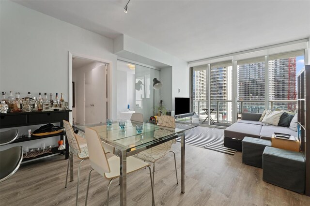 253 NE 2nd St Unit 2201, Miami, FL 33132 - kitchen with appliances with stainless steel finishes, dark countertops, a peninsula, and light wood-style floors