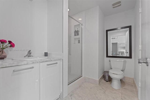 253 NE 2nd St Unit 2201, Miami, FL 33132 - bathroom featuring a stall shower, baseboards, vanity, and toilet