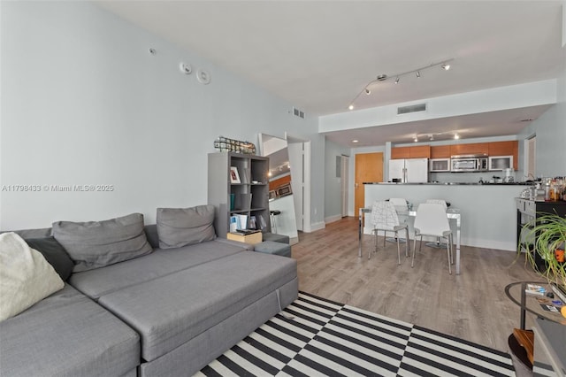 253 NE 2nd St Unit 2201, Miami, FL 33132 - living area with light wood-style flooring and baseboards