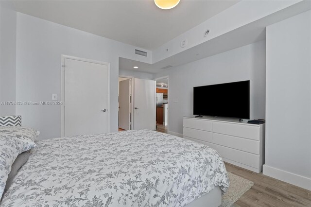 253 NE 2nd St Unit 2201, Miami, FL 33132 - bedroom with wood finished floors, baseboards, and recessed lighting