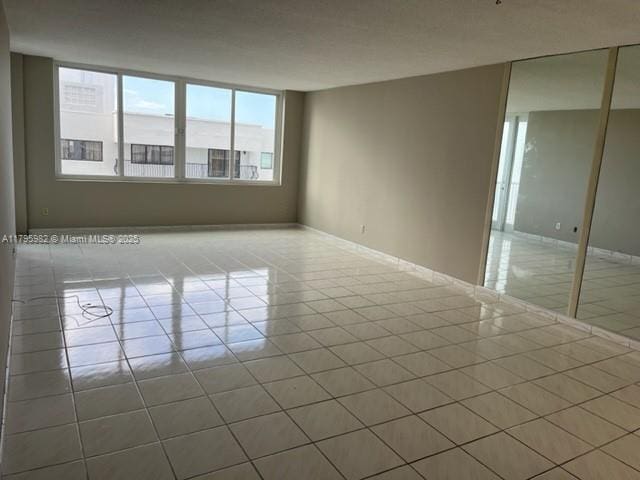 tiled spare room with baseboards