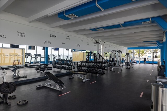 gym featuring beamed ceiling