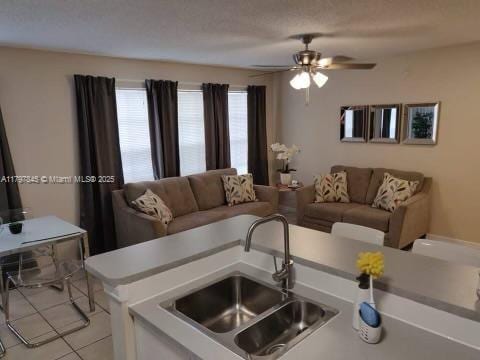 living room featuring light tile patterned floors and ceiling fan