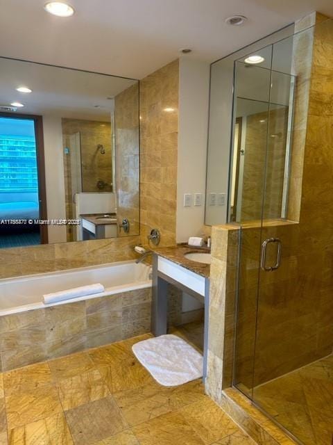 full bath featuring a shower stall, a bath, vanity, and recessed lighting