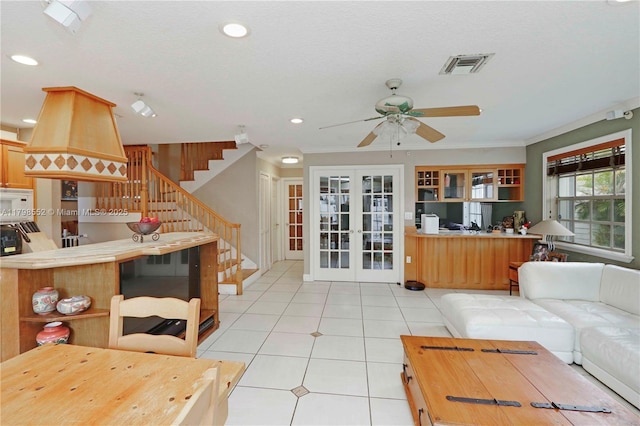 15007 SW 141st Pl, Miami, FL 33186 - living area with a ceiling fan, light tile patterned floors, stairs, ornamental molding, and french doors