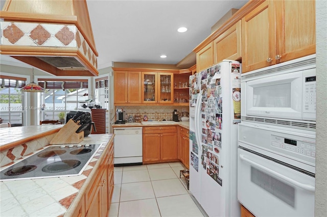 15007 SW 141st Pl, Miami, FL 33186 - kitchen with white appliances, tile countertops, a sink, decorative backsplash, and glass insert cabinets