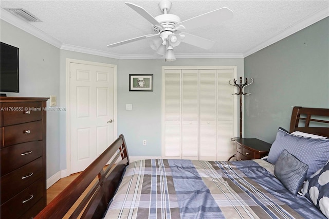 15007 SW 141st Pl, Miami, FL 33186 - bedroom featuring a closet, a textured ceiling, crown molding, a ceiling fan, and baseboards
