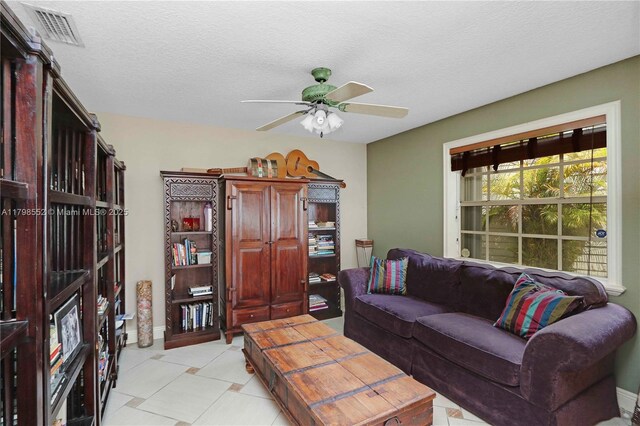 15007 SW 141st Pl, Miami, FL 33186 - living room featuring a ceiling fan, a textured ceiling, and baseboards