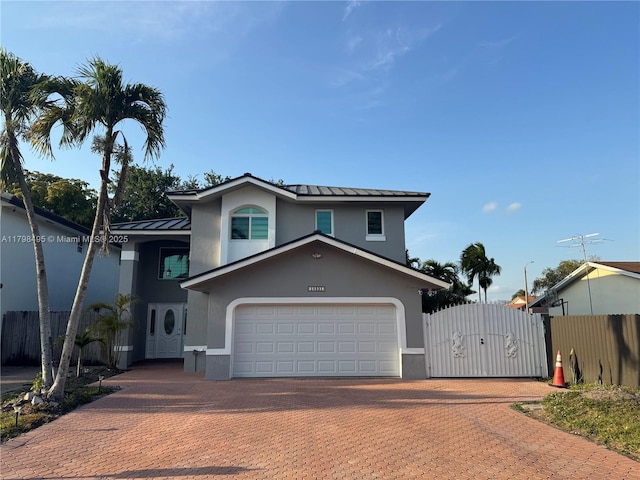 10331 SW 20th Ter, Miami, FL 33165 - view of front facade with stucco siding, fence, a standing seam roof, and a gate