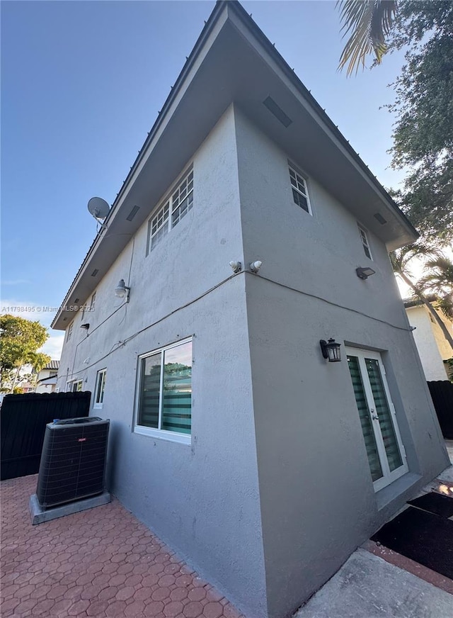 10331 SW 20th Ter, Miami, FL 33165 - view of property exterior featuring stucco siding, central air condition unit, and fence