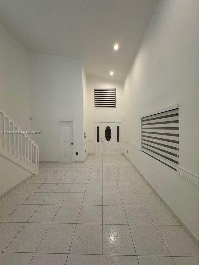 10331 SW 20th Ter, Miami, FL 33165 - unfurnished living room with tile patterned floors, recessed lighting, a towering ceiling, and baseboards