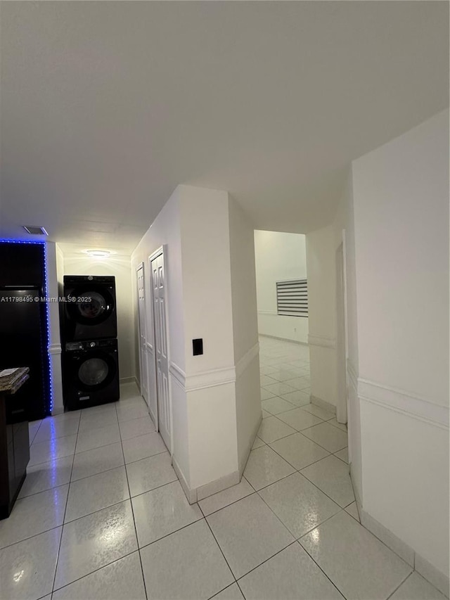 10331 SW 20th Ter, Miami, FL 33165 - hallway featuring estacked washer and dryer, light tile patterned floors, and baseboards