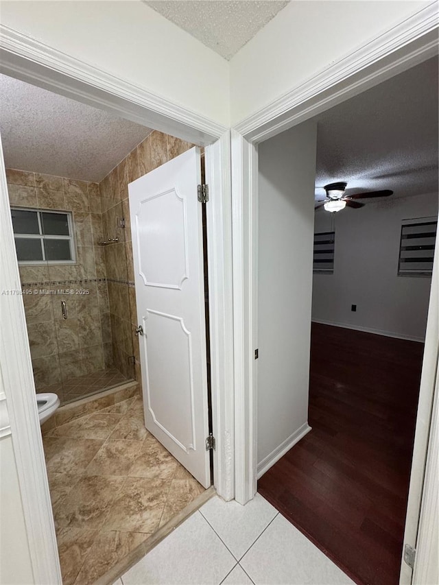 10331 SW 20th Ter, Miami, FL 33165 - hallway featuring a textured ceiling, tile patterned flooring, and baseboards