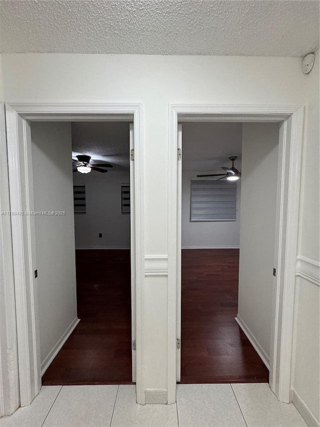 10331 SW 20th Ter, Miami, FL 33165 - hallway with tile patterned flooring, a textured ceiling, and baseboards