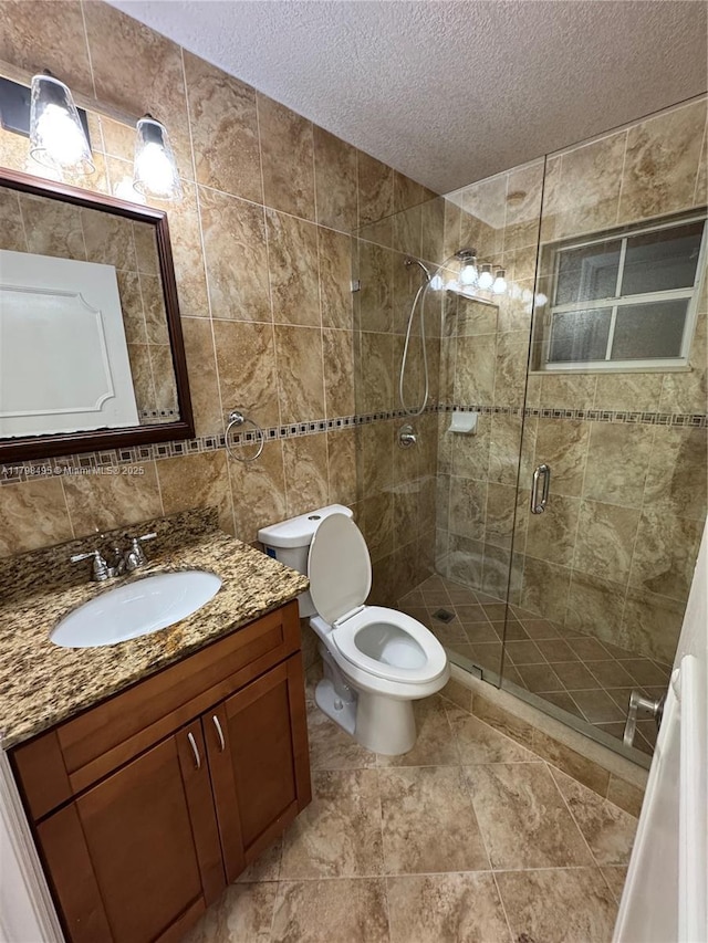 10331 SW 20th Ter, Miami, FL 33165 - bathroom featuring a textured ceiling, tile walls, a stall shower, vanity, and toilet