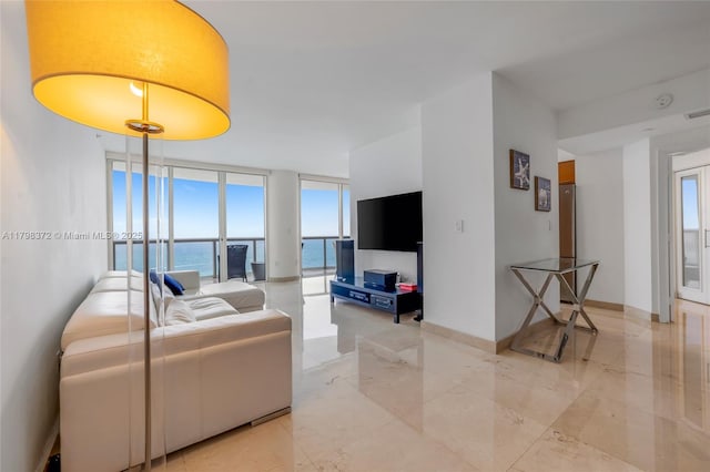 6365 Collins Ave Unit 3202, Miami Beach, FL 33141 - living room with a wall of windows and light marble finish flooring