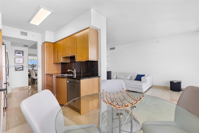 6365 Collins Ave Unit 3202, Miami Beach, FL 33141 - kitchen featuring a sink, stainless steel dishwasher, dark countertops, and backsplash