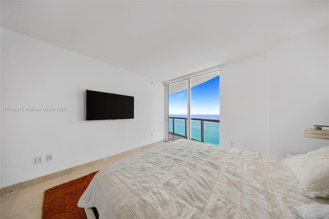 6365 Collins Ave Unit 3202, Miami Beach, FL 33141 - unfurnished bedroom featuring a wall of windows and access to exterior