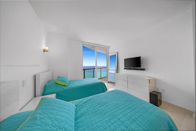 6365 Collins Ave Unit 3202, Miami Beach, FL 33141 - tiled bedroom with radiator, access to exterior, and a wall of windows