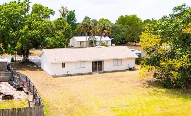 4023 E Palomar Cir, La Belle, FL 33935 - rear view of property with an outdoor fire pit