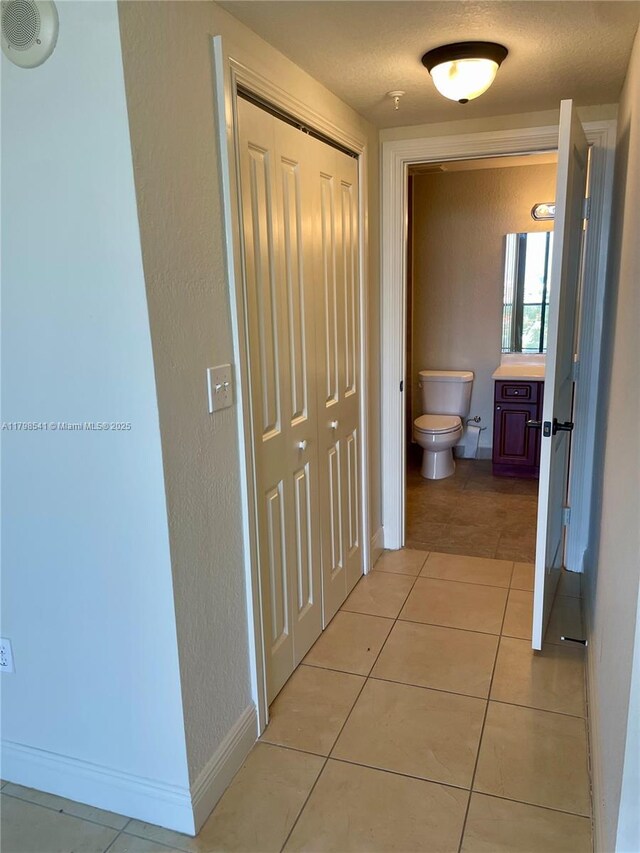 2301 SW 27th Ave Unit 802, Miami, FL 33145 - hall featuring light tile patterned flooring and baseboards