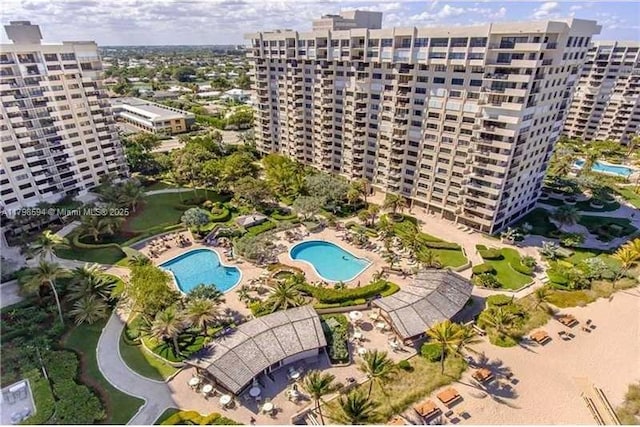view of urban area featuring a pool area and apartment complex / building