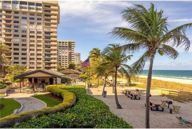 view of home's community with view of water and beach