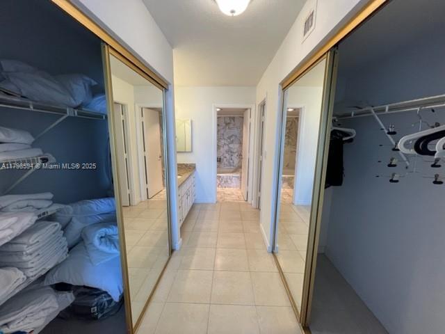 hallway featuring light tile patterned flooring