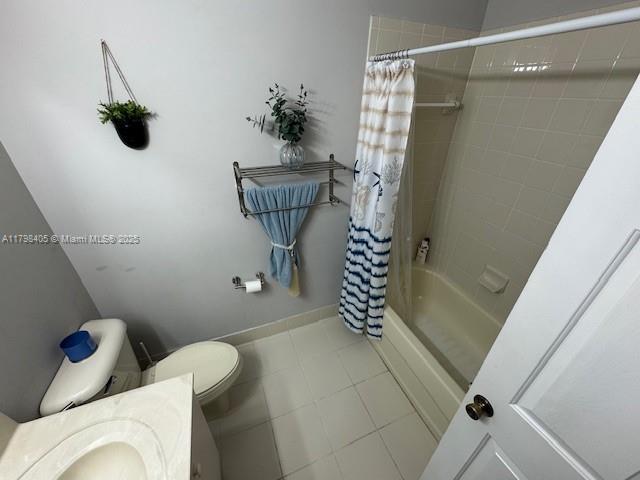 bathroom with toilet, shower / bathtub combination with curtain, vanity, and tile patterned floors