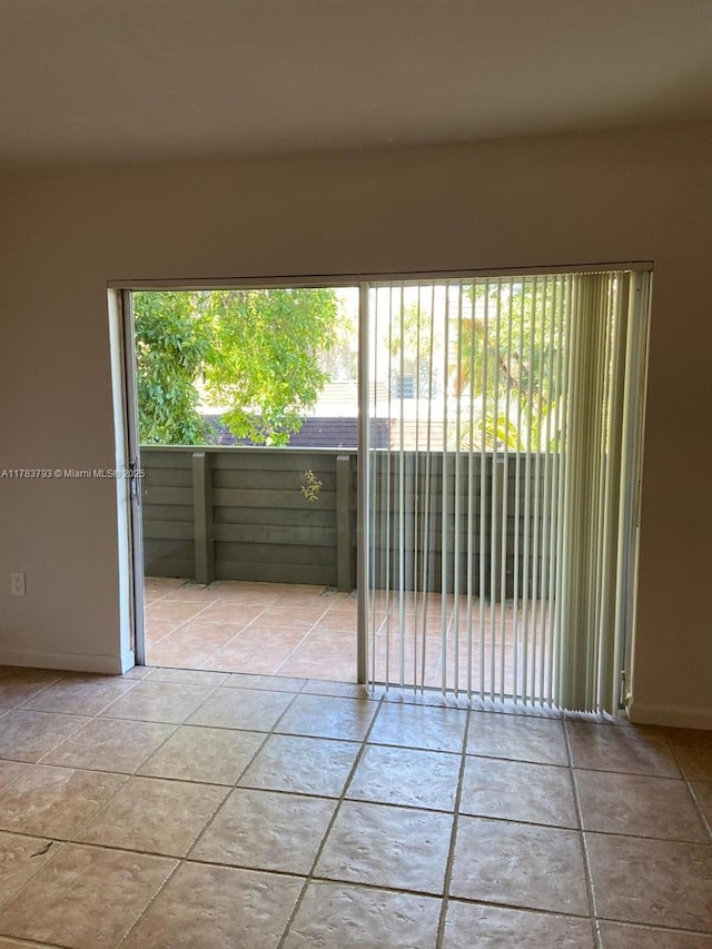 8335 SW 72nd Ave Unit 202D, Miami, FL 33143 - spare room featuring tile patterned flooring and baseboards