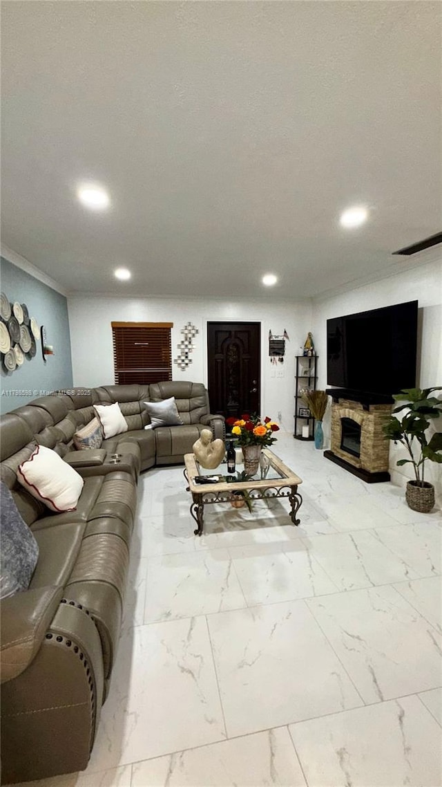 living area with marble finish flooring, recessed lighting, a fireplace, and crown molding