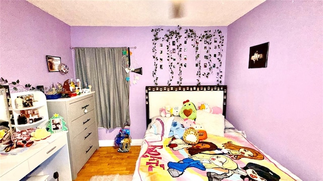bedroom featuring light wood-type flooring and baseboards