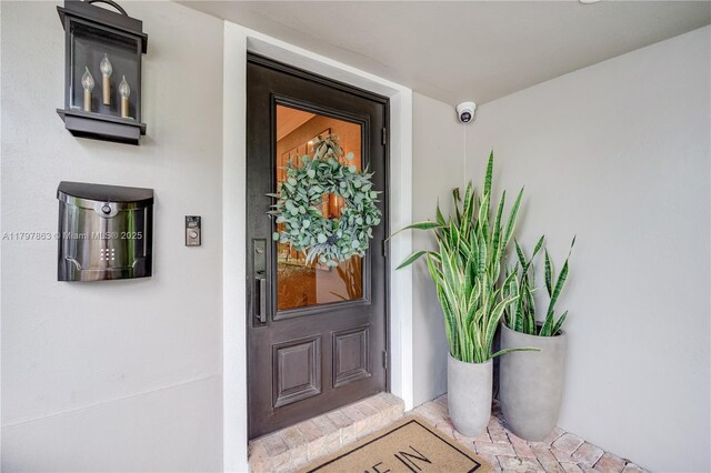 10921 SW 102nd Ct, Miami, FL 33176 - entrance to property with stucco siding and a surveillance system