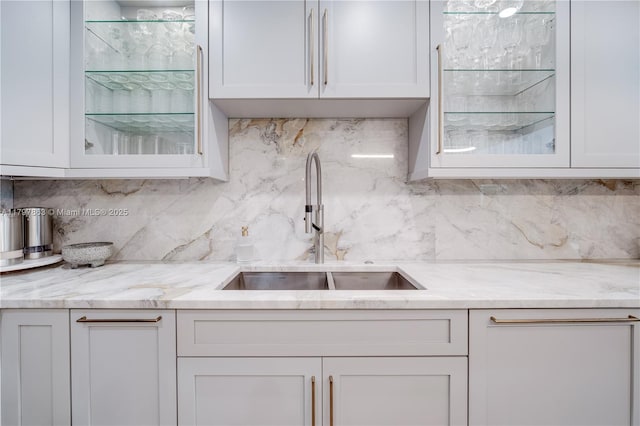 10921 SW 102nd Ct, Miami, FL 33176 - kitchen featuring a sink, glass insert cabinets, tasteful backsplash, and white cabinets