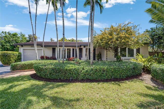10921 SW 102nd Ct, Miami, FL 33176 - view of front of property featuring an attached garage, a front yard, and stucco siding