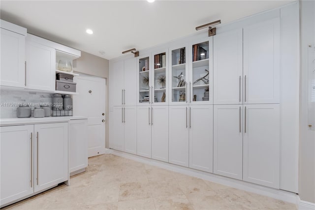 10921 SW 102nd Ct, Miami, FL 33176 - kitchen with open shelves, white cabinetry, glass insert cabinets, backsplash, and light countertops
