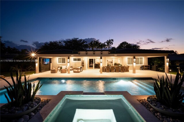 10921 SW 102nd Ct, Miami, FL 33176 - rear view of property featuring a patio, outdoor lounge area, and a pool with connected hot tub