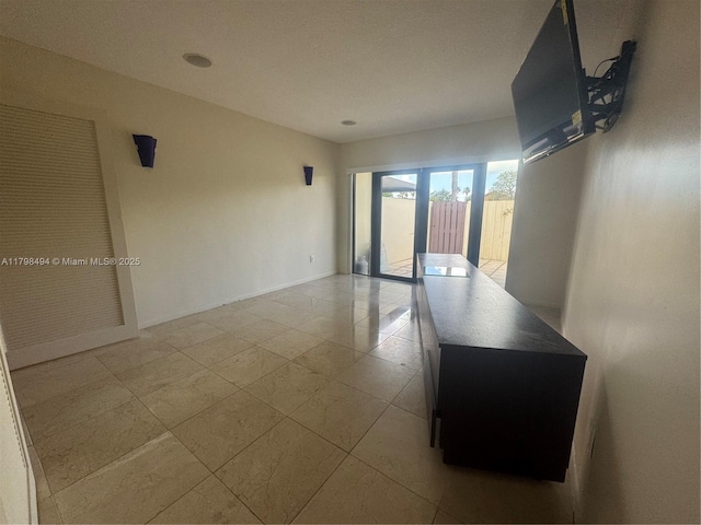 spare room with baseboards