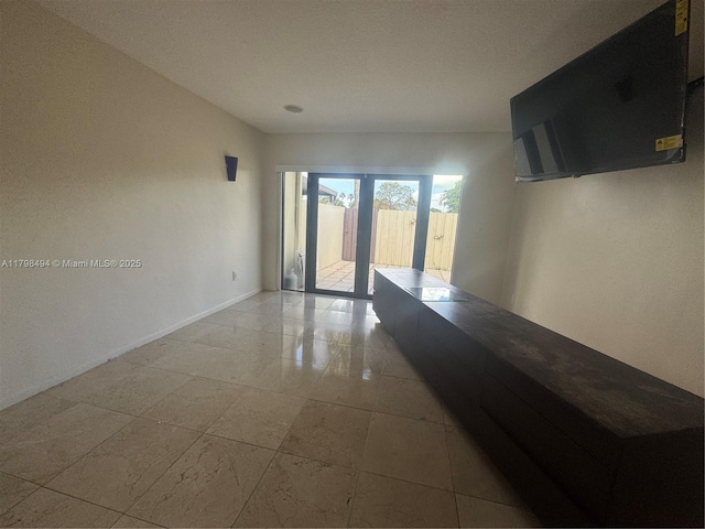 spare room featuring baseboards