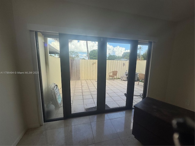 doorway featuring baseboards