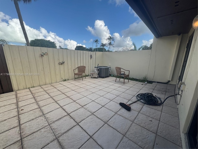 view of patio / terrace with central AC and fence