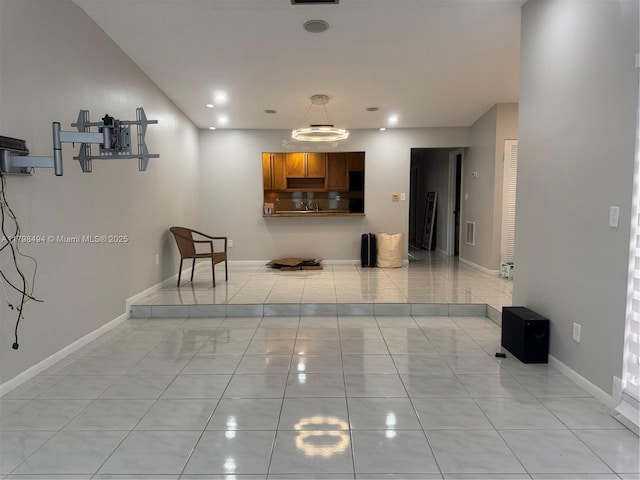 hallway featuring light tile patterned floors, baseboards, and recessed lighting
