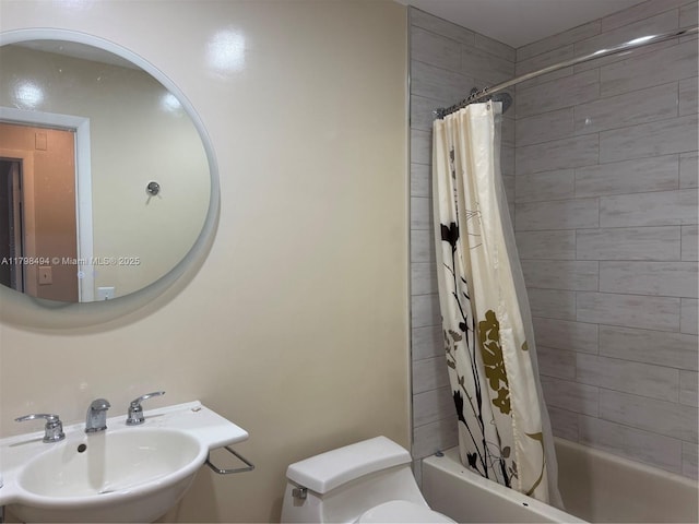 full bath with a sink, toilet, and shower / bathtub combination with curtain