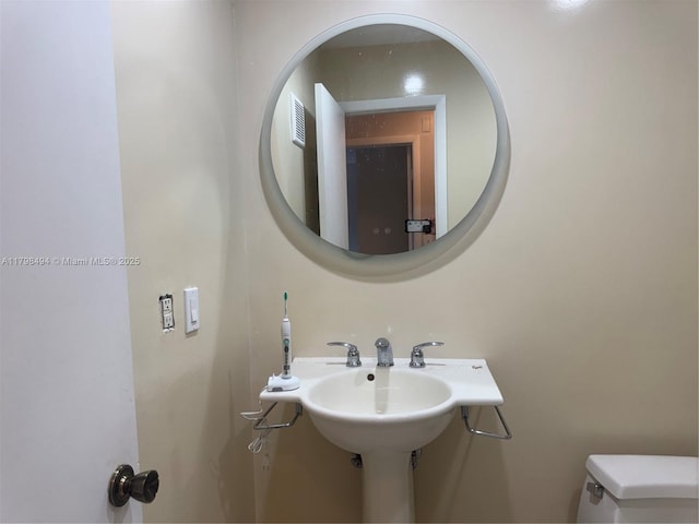 half bathroom featuring toilet