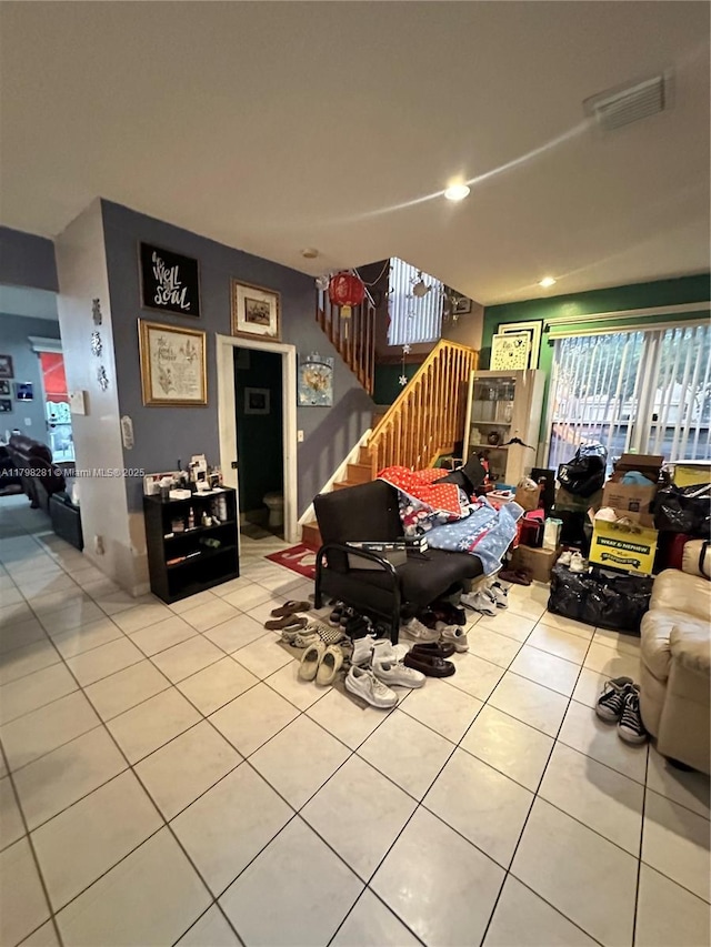 living room with light tile patterned flooring and stairs