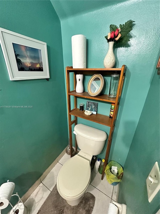bathroom with tile patterned flooring and toilet
