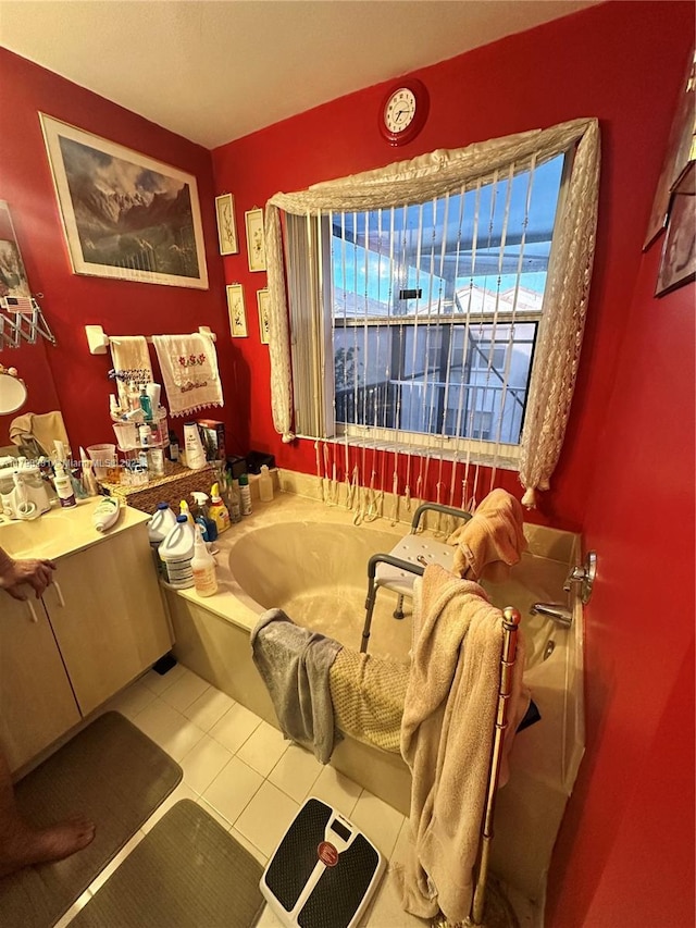 bathroom with a garden tub and tile patterned floors