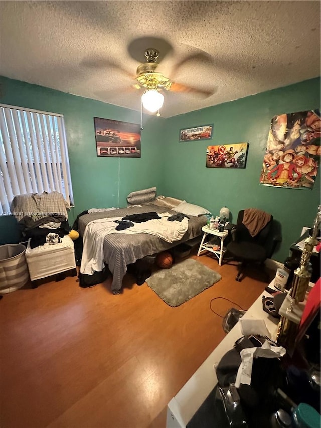 bedroom featuring a textured ceiling and a ceiling fan